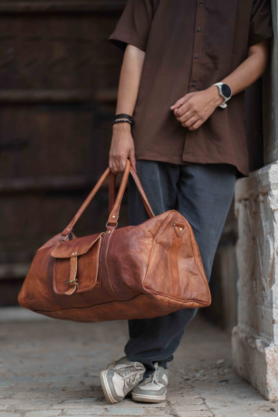 Brown leather duffel carried on a day out