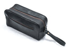 Black toiletry bag with zippered compartments and a wrist strap, three-quarter view.