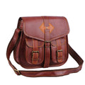 Reddish-brown crossbody satchel with two buckle pockets and a shoulder strap, three-quarter view.