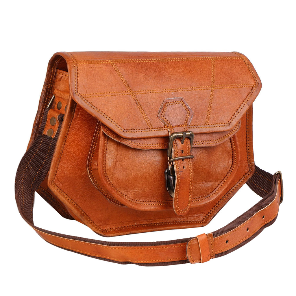 Tan crossbody bag with curved flap, front buckle pocket and adjustable strap, three-quarter view.