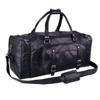 Black duffel bag with twin handles, buckle pockets and padded shoulder strap, three-quarter view.